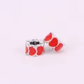 Macro view of two silver heart-shaped enamel beads for DIY jewelry bracelet making - Red