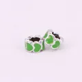 Macro shot of silver alloy heart charms with vibrant green enamel heart patterns - Grass Green