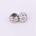 Detailed view of silver heart charms with white enamel dots for DIY jewelry making - White