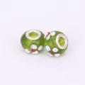 Macro detail of green glass beads with handmade floral patterns and silver metal cores - 15x10mm / Light Green