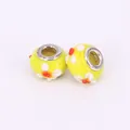 Macro view of yellow glass large hole charm beads with white and orange flower petals - 15x10mm / Yellow