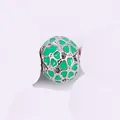 Macro shot of silver hollow charm featuring green enamel heart patterns for DIY bracelets - Green