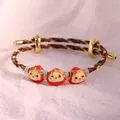 Detailed view of woven Dragon Boat festival bracelet with red enamel charms - Multicolor Rope + 3 Red Rice Dumplings