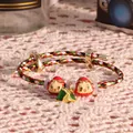 Dettaglio del bracciale colorato con ciondoli Daruma rossi e un pendente zongzi - Corda Multicolore + 2 Rossi + 1 Zongzi Verde