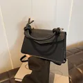 Black textured leather small square bag with unique braided rope handle and gold accents - Black