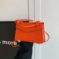 Vibrant orange textured leather small square bag with decorative knotted top handle - Orange