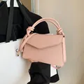 French style pink pebbled leather handbag with unique knotted handle and flap design - Pink