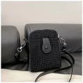 Close-up of black crossbody phone bag with rivet studs, chain strap and silver hooks - Black