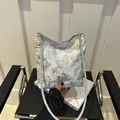 White fabric bucket bag featuring detailed gold and silver butterfly embroidery accents - Butterfly
