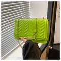 Detail of neon green crossbody bag with V-quilted stitching and gold chain strap - Green