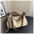 Detail of beige woven hobo bag with adjustable brown faux leather strap and metal buckle - Brown