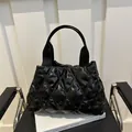 Chic black quilted puffer handbag with elegant diamond lattice stitching and soft texture - Black