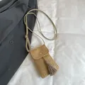 Beige woven straw phone crossbody bag with gold buckle and dark grey fringe tassel - Khaki