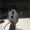 Dark grey bucket bag with black leather trim and golden twist lock closure - Dark Gray