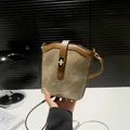 Retro khaki canvas bucket bag with brown leather trim and golden twist lock - Brown