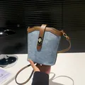 Blue suede and brown leather bucket bag with gold turn-lock and slim shoulder strap - Blue