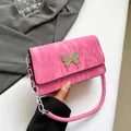 Pink Y2K shoulder bag featuring glossy pleated leather and silver butterfly metal detail - Pink