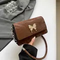 Brown chic underarm bag with silver butterfly buckle and stylish metal chain strap - Brown