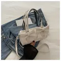Chic off-white cylinder bag with large bows and a detachable shoulder strap - White