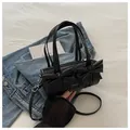 Black cylinder pleated bag with large bows and detachable strap in a stylish setup - Black