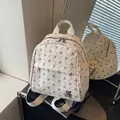 Mini cream backpack with rabbit patterns and adjustable straps in a mirror reflection - No Pendant / Off White