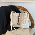 Minimalist beige tote bag with pleated texture and stylish knotted cord accessory - Beige