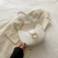 Minimalist white crescent shoulder bag with a gold horseshoe buckle and chain strap - White