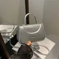 Silver metallic leather crossbody bag with top handle and gold Fashion logo lettering - Silver