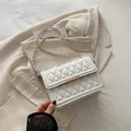 Elegant white quilted crossbody bag with gold chain strap and metallic lock closure - White