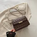 Quilted leather crossbody bag in dark brown with gold hardware and chain strap - Brown