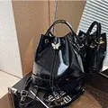 Glossy black pleated bucket bag featuring a silver butterfly buckle and drawstring - Black