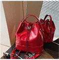 Glossy red drawstring bucket bag with metal butterfly ornament and adjustable strap - Burgundy