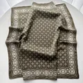 Macro detail of olive green silk scarf featuring white geometric patterns and ethnic border - 65x65cm / Matcha Green