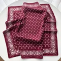 Detailed view of the soft silk-like texture and geometric floral pattern on a burgundy scarf - 65x65cm / Dark Red