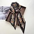 Black horse print silk satin skinny scarf styled in a luxury gift box display - Black