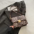Fashionable leopard print flap crossbody bag with a square golden metal twist lock - Brown