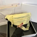 Pale yellow nylon crescent bag with adjustable shoulder strap and woven zipper detail - Yellow