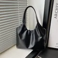Minimalist black pleated cloud hobo bag in soft faux leather for casual commuting style - Black