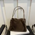 Deep brown faux fur tote bag with slim leather straps on a minimalist background - Brown