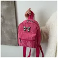 Detailed close-up of rose red mini backpack with a silver metal bow and nylon texture - Rose Red