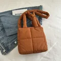 Quilted caramel puffer tote bag with padded handles and minimalist square design - Orange