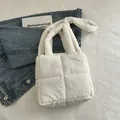 White quilted puffer tote bag with padded shoulder strap on a minimalist background - White