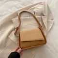 Minimalist caramel brown underarm bag with woven texture flap and knot strap detail - Khaki
