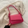 Minimalist bright pink shoulder bag with woven flap detail and stylish knot strap - Rose Red