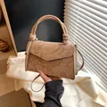Elegant beige crossbody bag with embossed koi and lotus patterns and top handle - Khaki