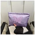Detail of lavender satin cosmetic bag with purple butterfly embroidery and gold zipper - Purple