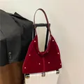 Burgundy velvet hobo bag with gold stud accents and elegant crescent shape design - Red