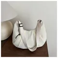 Detail of creamy nylon crescent bag with pleated texture and adjustable wide strap - White
