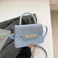 Light blue contrast-panel crossbody bag with gold buckle and top handle details - Blue