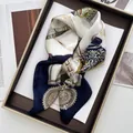 Detail of luxury baroque silk scarf with gold chain pattern on a decorative gold tray - Dark Blue